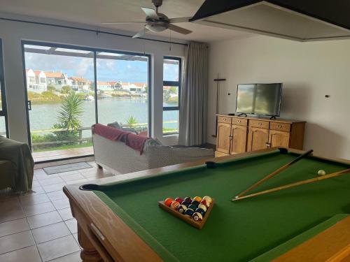 a living room with a pool table and a tv at Skoenlapper holiday home in Velddrif