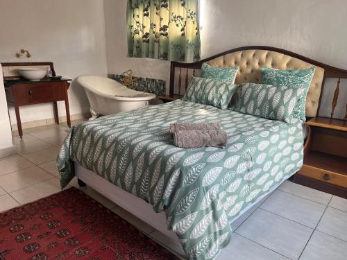 a bedroom with a bed and a tub and a toilet at Skoenlapper holiday home in Velddrif