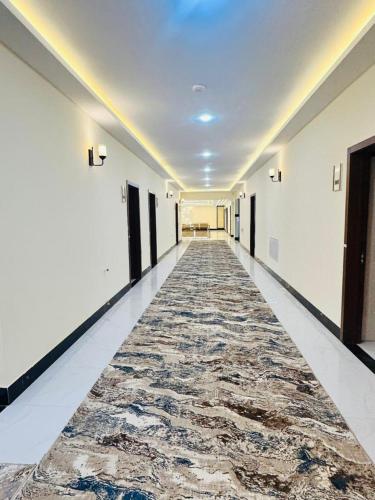 an empty hallway with a rug on the floor at Herat Star Hotel in Herāt
