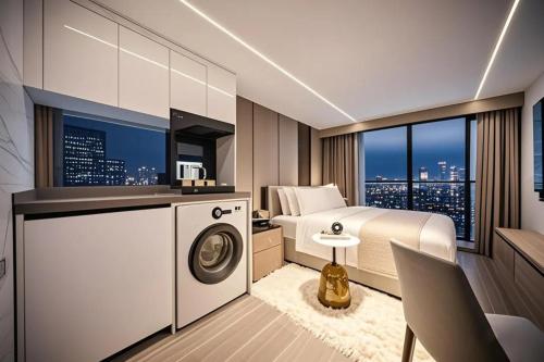 a bedroom with a bed and a washing machine at Meipeng Light Luxury-Olympic Sports Center International Financial City Store in Guangzhou
