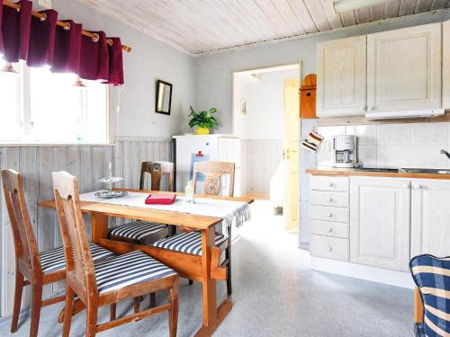 a kitchen with a wooden table and chairs at 4 person holiday home in Årjäng in Årjäng