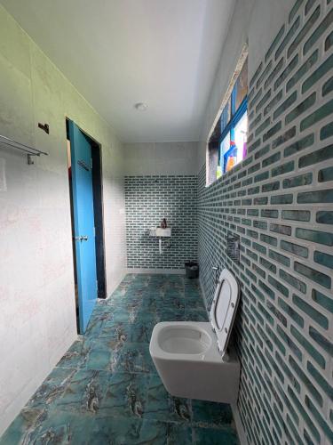 a bathroom with a sink and a toilet in it at Aweka Villa - 3 BHK Riverside - Karjat in Dhamni