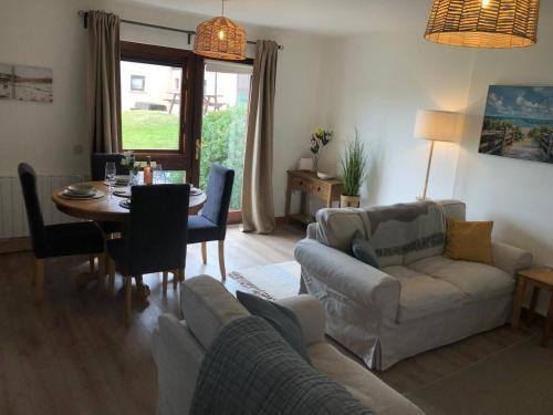 a living room with a couch and a table at Bayview Villa Costal Retreat in Youghal