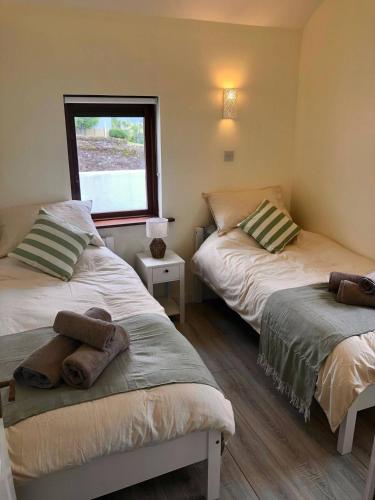 a room with two beds and a window at Bayview Villa Costal Retreat in Youghal