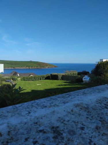 a view of a golf course with the ocean in the background at Bayview Villa Costal Retreat in Youghal