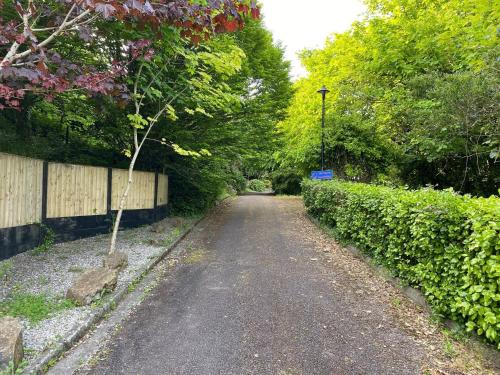 a dirt road in a park with a fence and trees at Bayview Villa Costal Retreat in Youghal