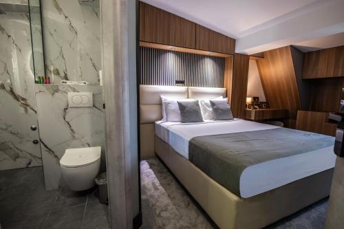 a hotel room with a bed and a bathroom at View Inn Boutique Hotel in Skopje