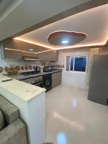 a kitchen with a sink and a stove top oven at Résidence Assalam - en bord de mer in Azla