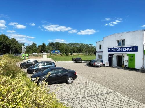 a group of cars parked in a parking lot at Pension Zur Mühle in Grifte