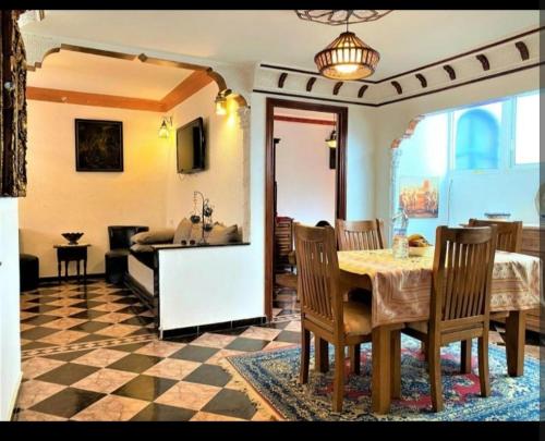 a kitchen and dining room with a table and chairs at étage 1 avec terrasse et vue sur mer in El Jadida