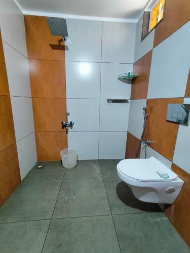 a bathroom with a toilet and a shower at Natura La Casa in Idukki
