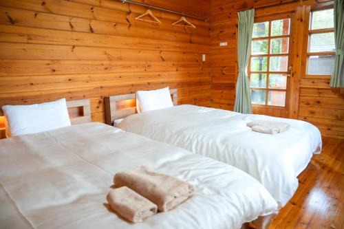 Una cama o camas en una habitación de Sakata Log House 酒田ログハウス