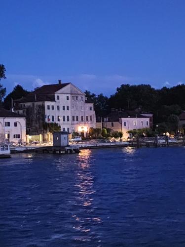 a group of buildings on the shore of a body of water at Il Glicine di Marco Polo in Cavallino-Treporti