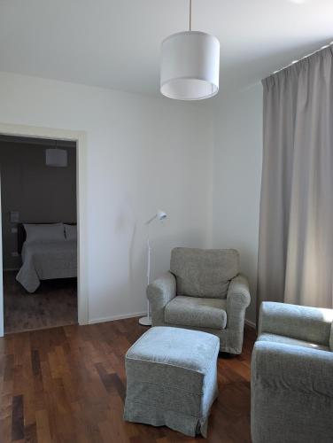 a living room with a chair and a chair and a couch at Al tempo ritrovato Country house in Pianfei