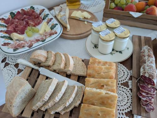 a table topped with plates of bread and sandwiches at Al tempo ritrovato Country house in Pianfei