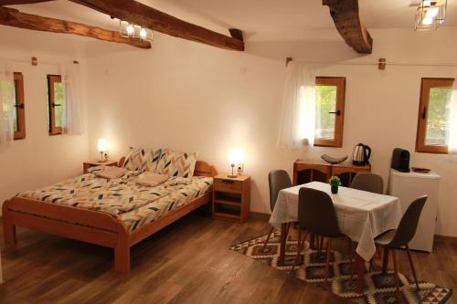 a bedroom with a bed and a table and chairs at Ижата 2 in Borovitsa