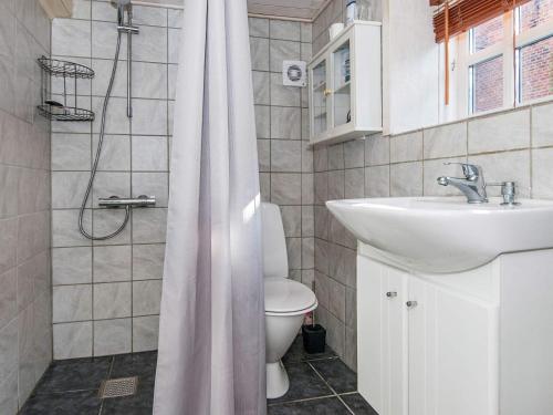 a bathroom with a sink and a toilet and a shower at Cozy Seaside Retreat in Hojer-By Traum in Højer