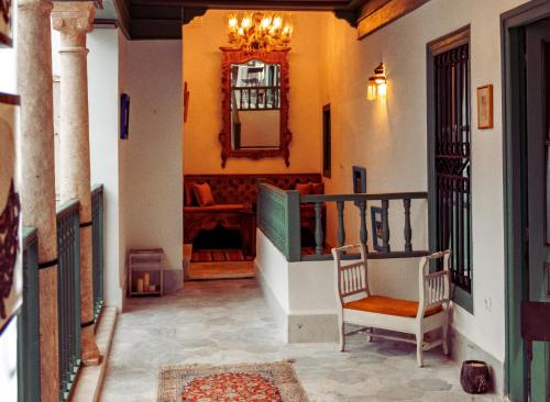 a hallway with two chairs and a mirror on the wall at Dar May - Maison d'hôte in Tunis