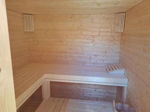 a wooden sauna with a bench in it at Vár-Völgye Vendégház in Csesznek