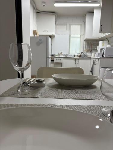 a table with a wine glass and a plate on it at 루나스테이 in Seoul