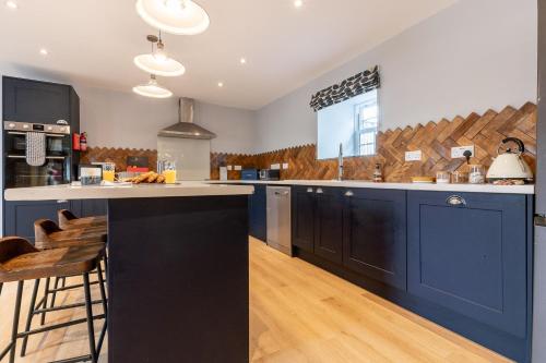 a kitchen with blue cabinets and a counter top at The Stables in Holyhead