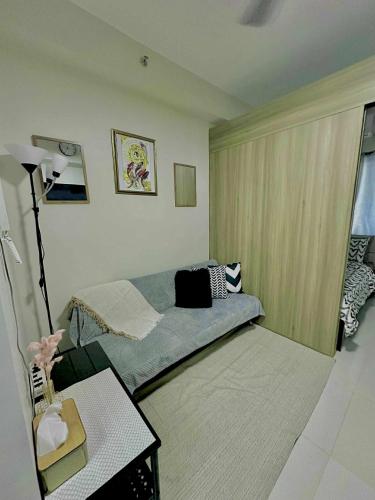 a room with a bed and a table in a room at Fame Residences in Sampong