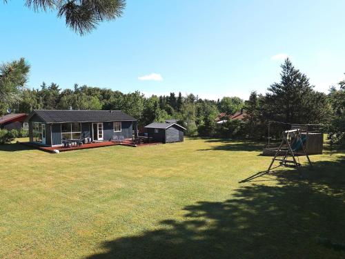 a large yard with a house and a playground at 6 person holiday home in Nibe-By Traum in Nibe
