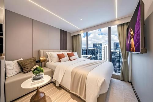 a hotel room with a large bed and a couch at Meipeng Light Luxury-Olympic Sports Center International Financial City Store in Guangzhou