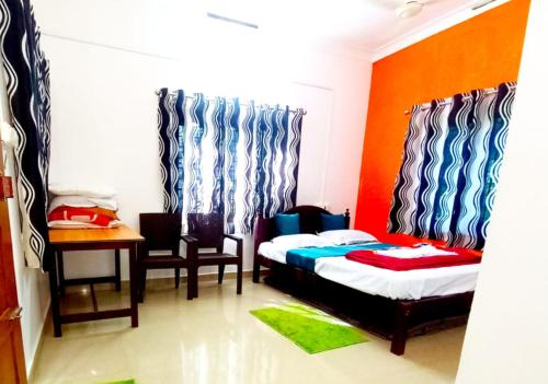 a bedroom with a bed and a desk and a table at Misty valley Private Pool Villa Munnar in Anachal