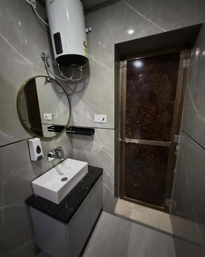 a bathroom with a sink and a shower with a mirror at Hotel Archit International in Jāmb