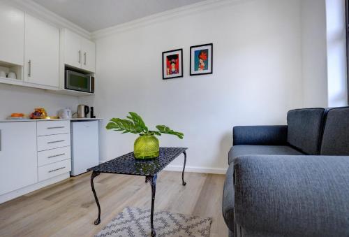 a living room with a couch and a table at Bay Lodge on the Beach in Mossel Bay