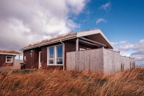 a small house sitting on top of a hill at Blue View Cabins in Reykholt