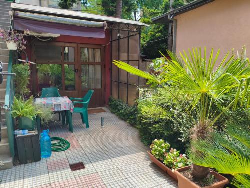 a patio with a table and chairs and plants at Studio House - Getaway in Bitola