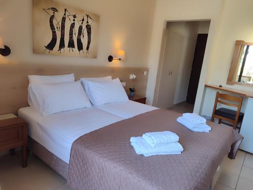 Hotel Prigipikon Suites and sofitesにあるベッド