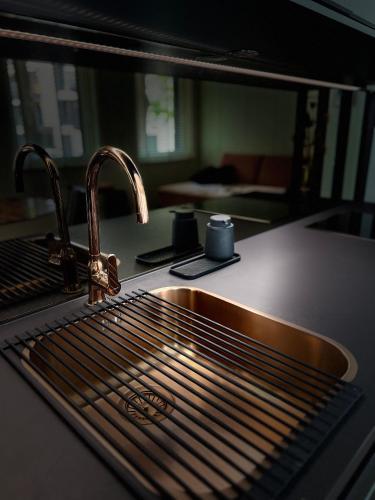 a kitchen counter with a sink and a microwave at Lux city apartment in Luxembourg