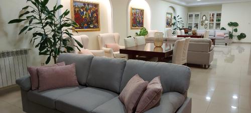 a living room with a couch and a table at Apartamentos Maritimo Suites-Solo Adultos in O Grove