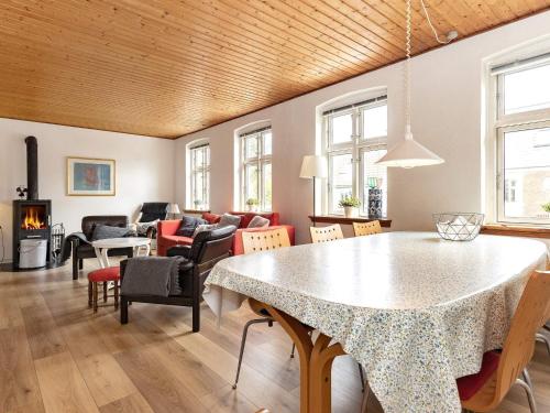 a living room with a table and chairs at 6 person holiday home in Marstal in Marstal