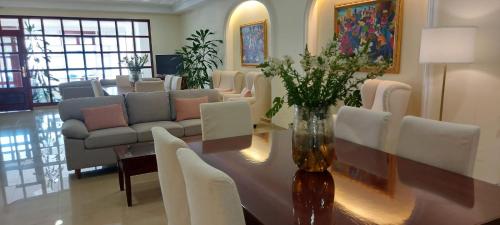 a living room with a table and chairs and a couch at Apartamentos Maritimo Suites-Solo Adultos in O Grove