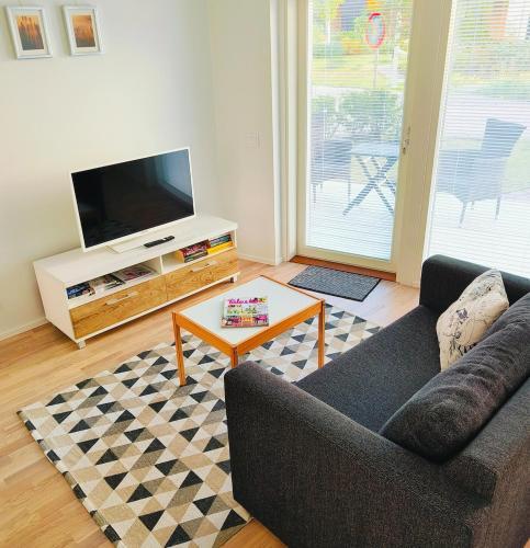 a living room with a couch and a coffee table at Long Journey Helsinki in Helsinki