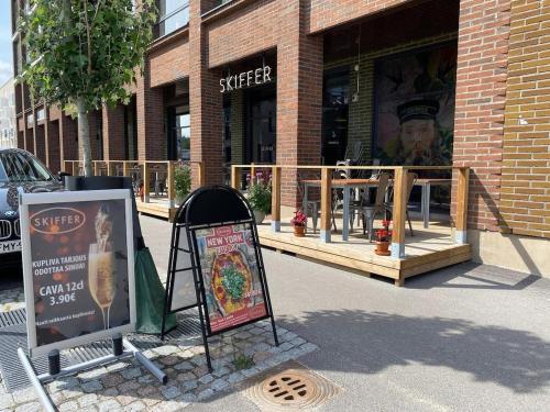 a store with a sign in front of a building at Long Journey Helsinki in Helsinki