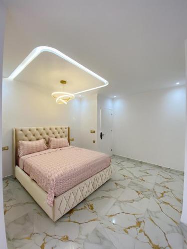 a bedroom with a bed in a room with marble floors at Casa almas in Chefchaouen