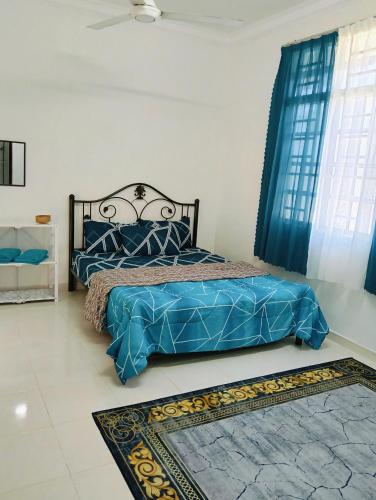 a bedroom with a bed with blue sheets and a window at nearby umt unisza hosza litar gong badak airport chelong homestay kuala terengganu in Kampong Bukit Berangan