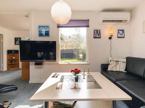 a living room with a coffee table and a tv at 7 person holiday home in Spøttrup in Spottrup