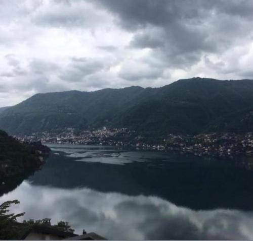 a large body of water with a city and mountains at Top Lake View in Faggeto Lario 