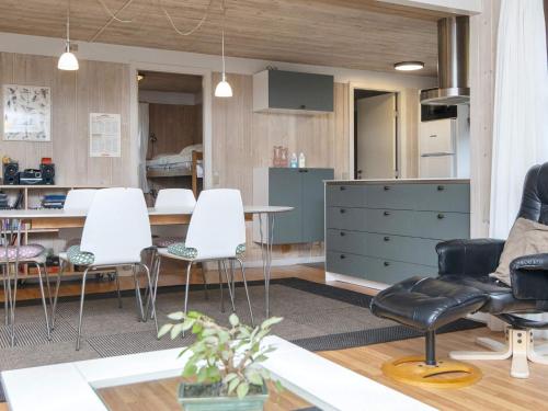 a living room with a table and white chairs at 10 person holiday home in Glesborg-By Traum in Fjellerup Strand