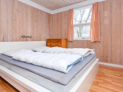 a large bed in a room with a window at 10 person holiday home in Glesborg-By Traum in Fjellerup Strand