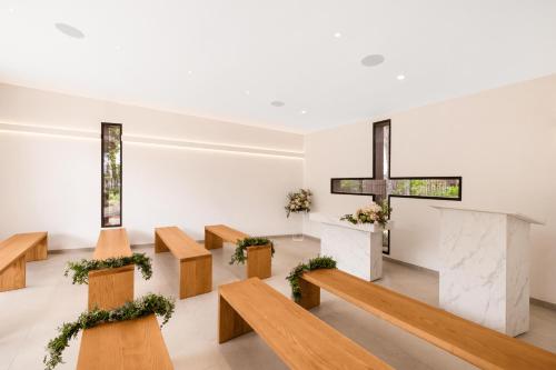 a church with wooden benches and a cross at Hotel Aubamar Suites & Spa in Playa de Palma