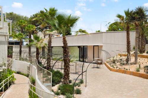 a building with palm trees in front of it at Hotel Aubamar Suites & Spa in Playa de Palma