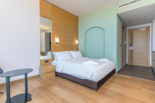 a bedroom with a bed and a desk and a table at Jounieh Living - Residences by Local Host in Ed Dkârîne