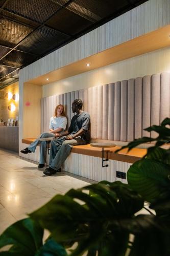 a man and a woman sitting on a bench at Citybox Brussels in Brussels